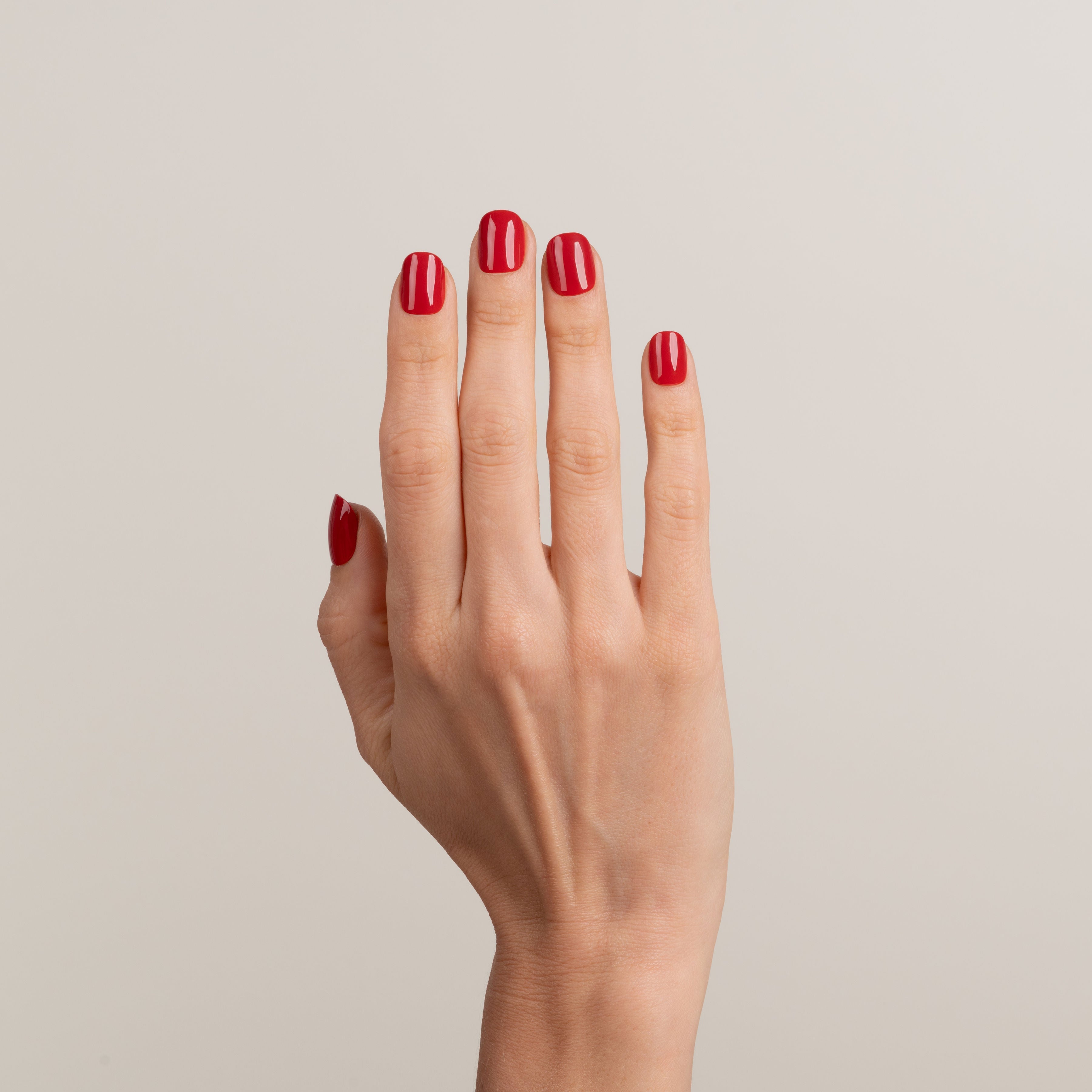 Hand with red nail polish